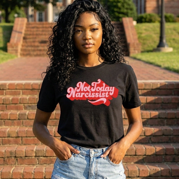 Person wearing a black t-shirt with not today narcissist red text standing outdoors on steps.