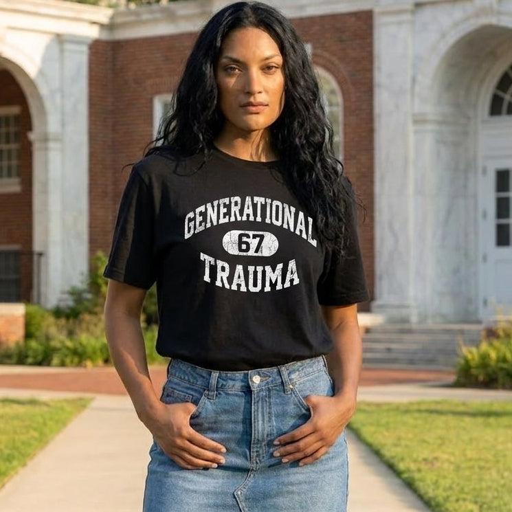 Woman wearing a black t-shirt with 'Generational Trauma 67' text in front of a building.
